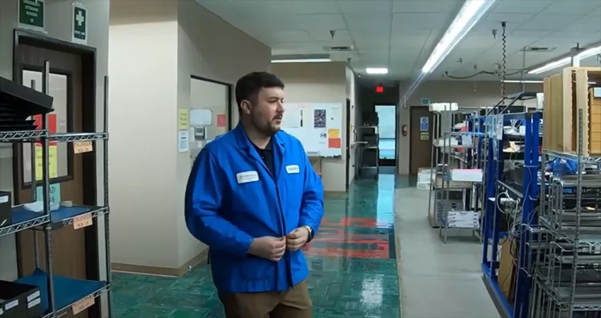 PCB factory employee wearing an ESD smock
