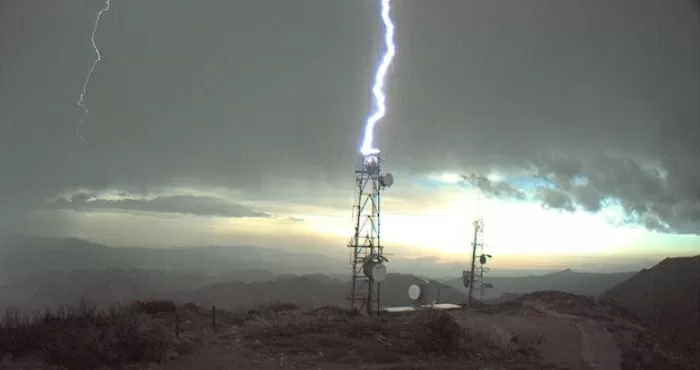 Lightning strikes cell tower.